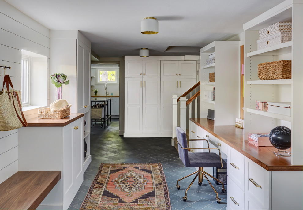 Mittelgroßes Landhaus Nähzimmer mit weißer Wandfarbe, Schieferboden, Einbau-Schreibtisch, grauem Boden und Holzdielenwänden in Sonstige