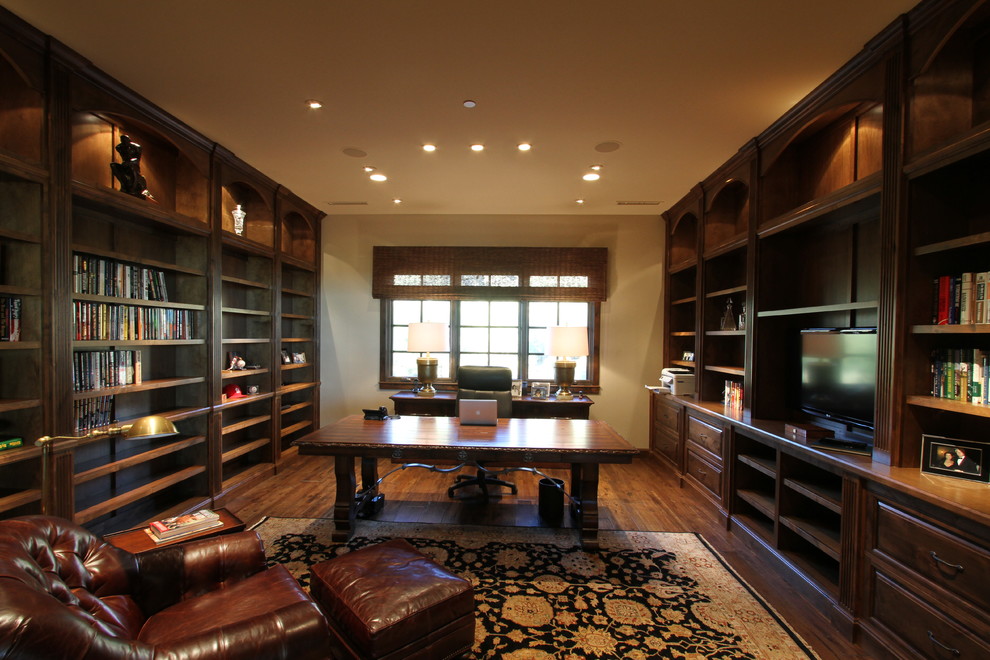 Expansive classic study in Phoenix with dark hardwood flooring and a freestanding desk.
