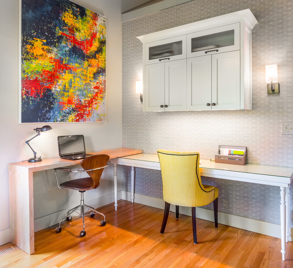 Study room - mid-sized transitional built-in desk medium tone wood floor study room idea in Seattle with gray walls
