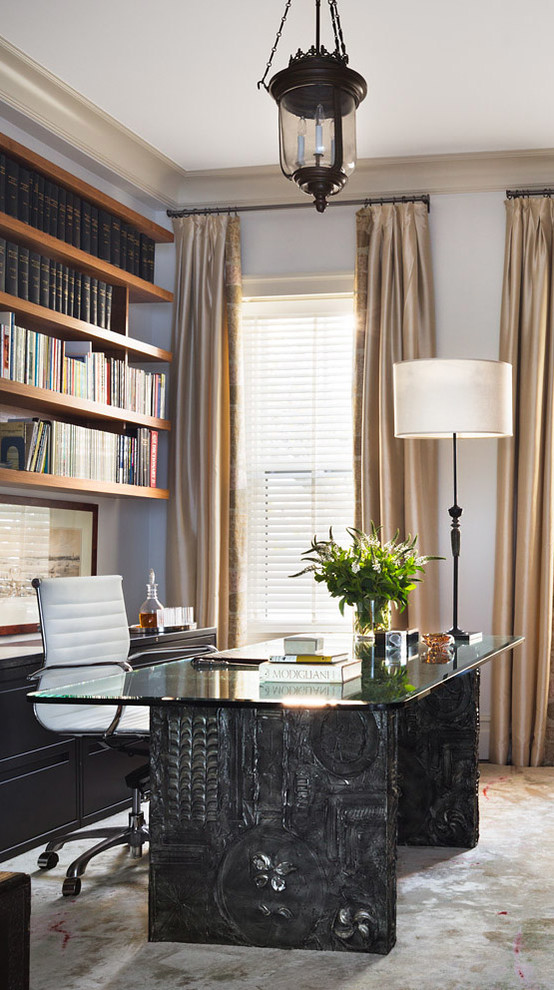 This is an example of a classic study in New York with white walls, carpet, a freestanding desk and no fireplace.