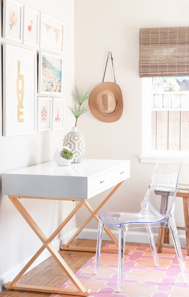 Transitional freestanding desk light wood floor study room photo in Santa Barbara with beige walls
