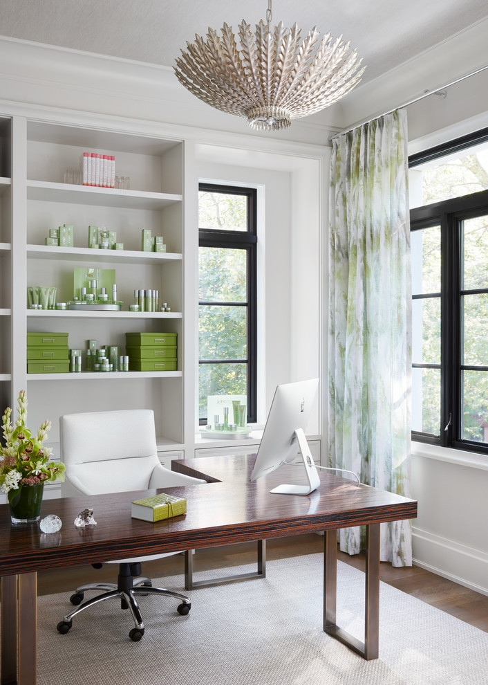 Home office - transitional freestanding desk medium tone wood floor and brown floor home office idea in Chicago with white walls