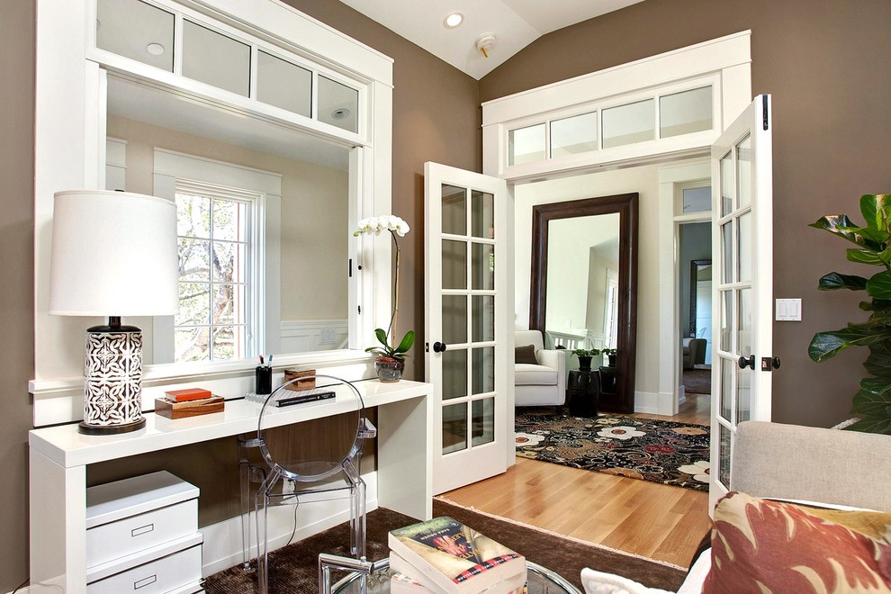 Inspiration for a transitional medium tone wood floor home office remodel in San Francisco with brown walls