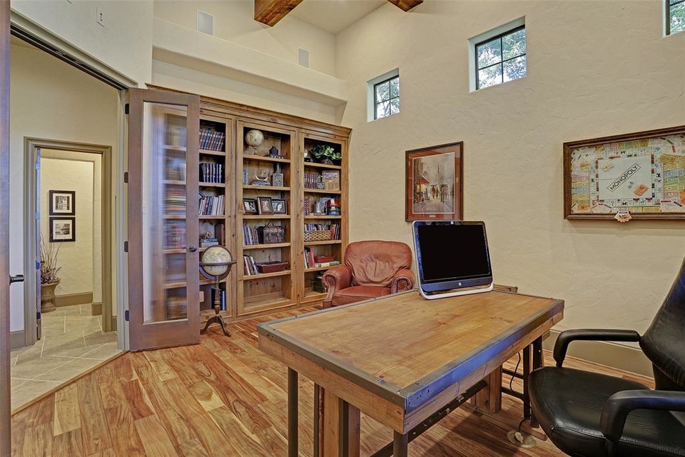 Diseño de despacho clásico renovado extra grande con biblioteca, paredes blancas, suelo de madera en tonos medios, escritorio independiente y suelo marrón