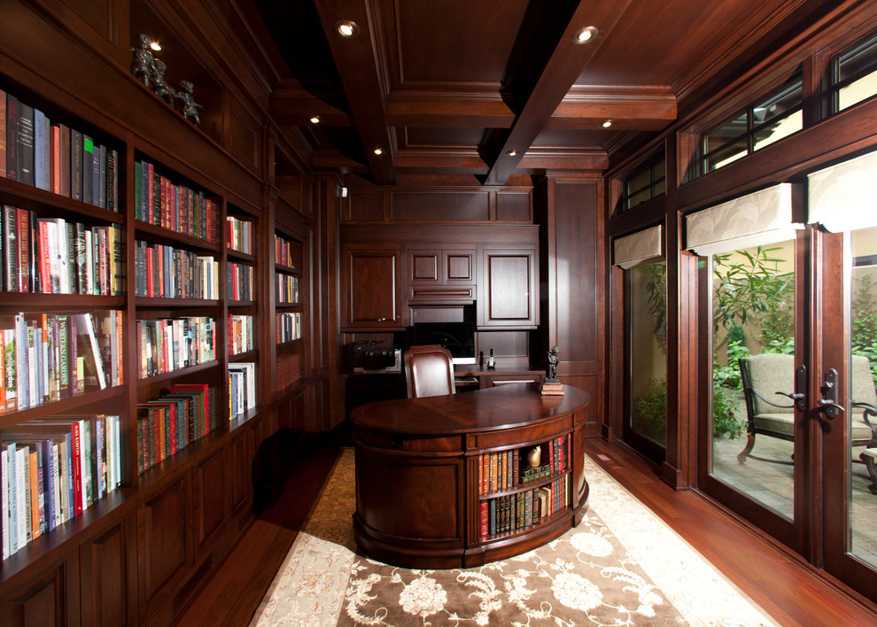 Inspiration pour un grand bureau traditionnel avec une bibliothèque ou un coin lecture, un mur rouge, un sol en bois brun, aucune cheminée, un bureau indépendant et un sol rouge.