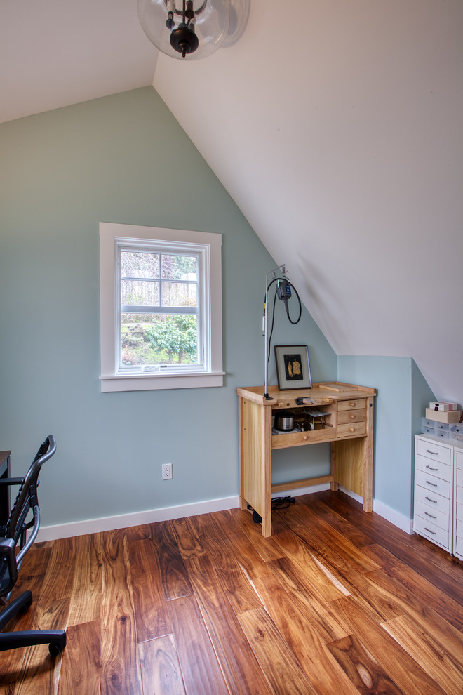 Craft room - small traditional freestanding desk medium tone wood floor and brown floor craft room idea in San Francisco with blue walls