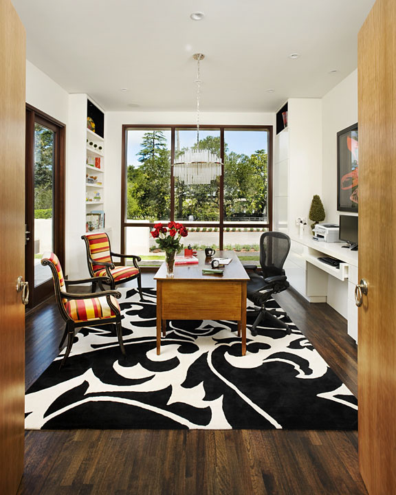 Example of a large trendy freestanding desk dark wood floor and brown floor study room design in San Francisco with white walls and no fireplace