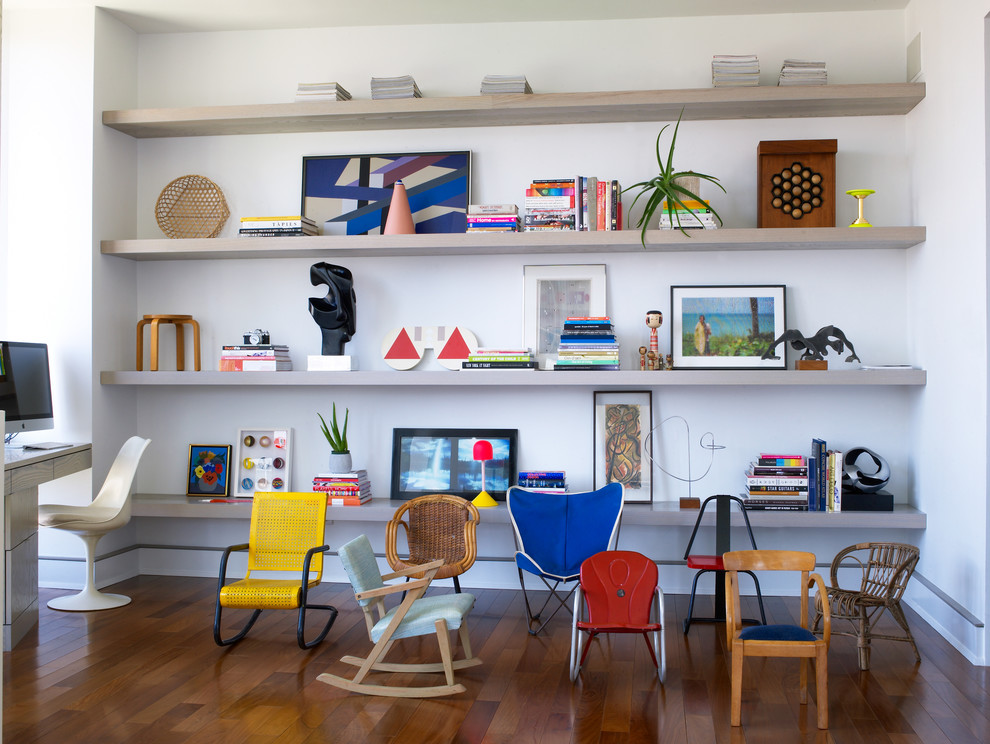 Large minimalist built-in desk medium tone wood floor home studio photo in New York with white walls