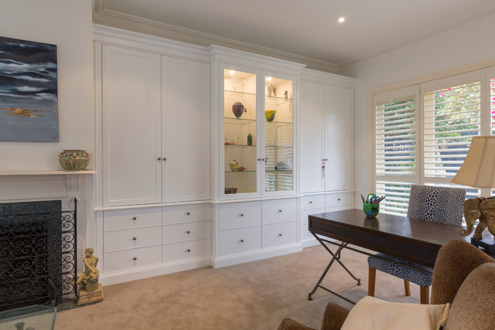 Inspiration for a large timeless freestanding desk carpeted and beige floor study room remodel in Melbourne with white walls, a standard fireplace and a stone fireplace