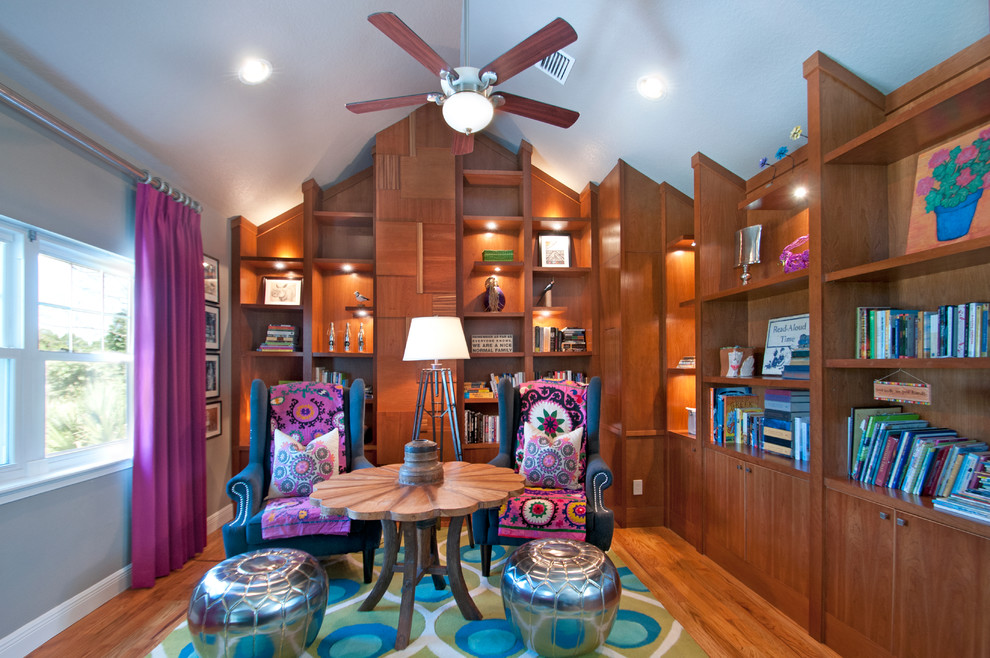 Example of an eclectic medium tone wood floor home office design in Orlando