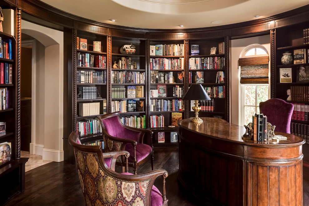 Photo of an expansive mediterranean home office in Kansas City with beige walls, dark hardwood flooring and a freestanding desk.