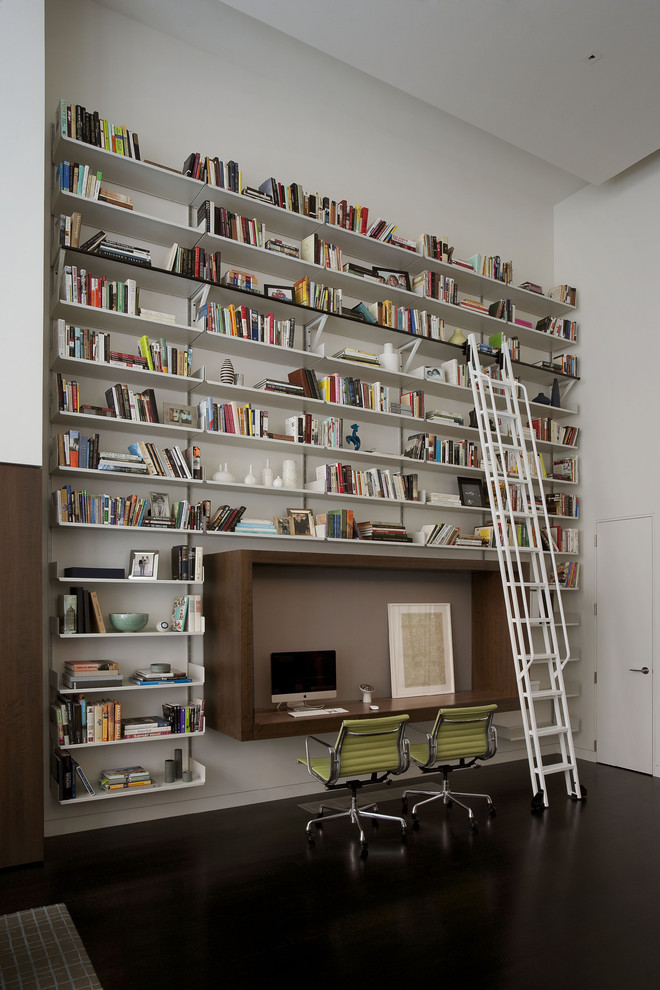 Inspiration for a contemporary built-in desk black floor home office remodel in New York with white walls