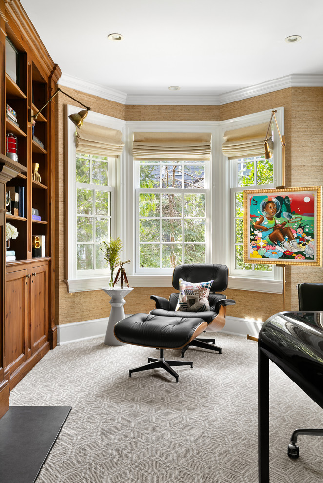 Photo of a medium sized modern home office in New York with carpet, a standard fireplace, a freestanding desk, beige floors and wallpapered walls.