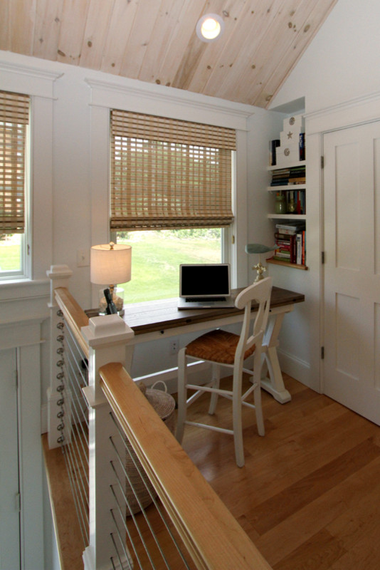 Mid-sized beach style freestanding desk medium tone wood floor study room photo in Boston with white walls