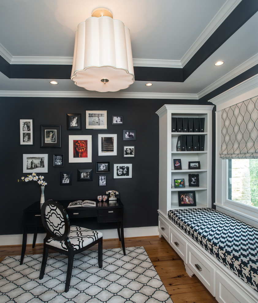 Study room - mid-sized traditional freestanding desk light wood floor study room idea in Houston with black walls and no fireplace