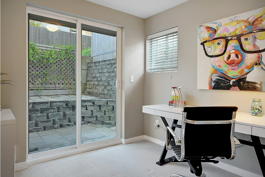 Photo of a small contemporary study in Seattle with beige walls, carpet, no fireplace and a freestanding desk.