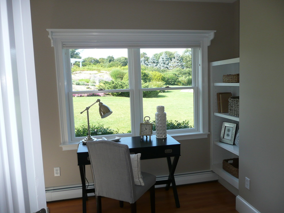This is an example of a medium sized beach style study in Boston with grey walls, no fireplace and a freestanding desk.