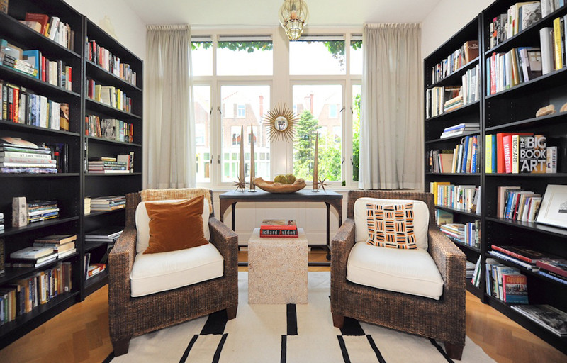 Inspiration for a small eclectic study in Amsterdam with white walls, medium hardwood flooring and no fireplace.