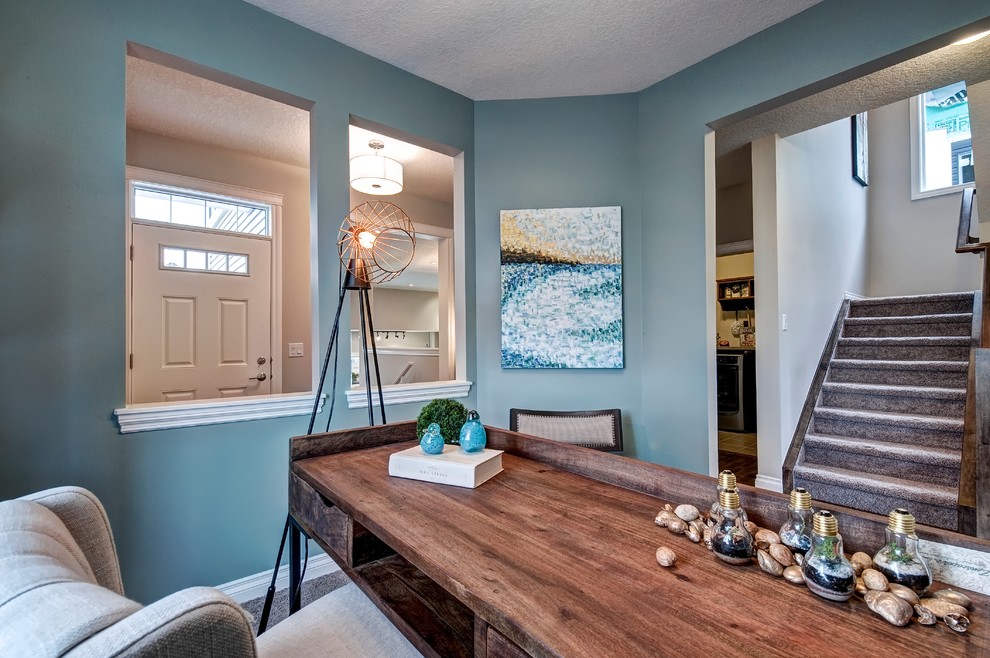 Источник вдохновения для домашнего уюта: кабинет в современном стиле с синими стенами, ковровым покрытием и отдельно стоящим рабочим столом без камина