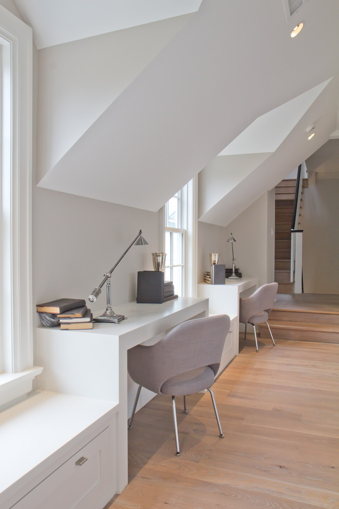 Example of a mid-sized farmhouse built-in desk light wood floor study room design in New York with white walls and no fireplace
