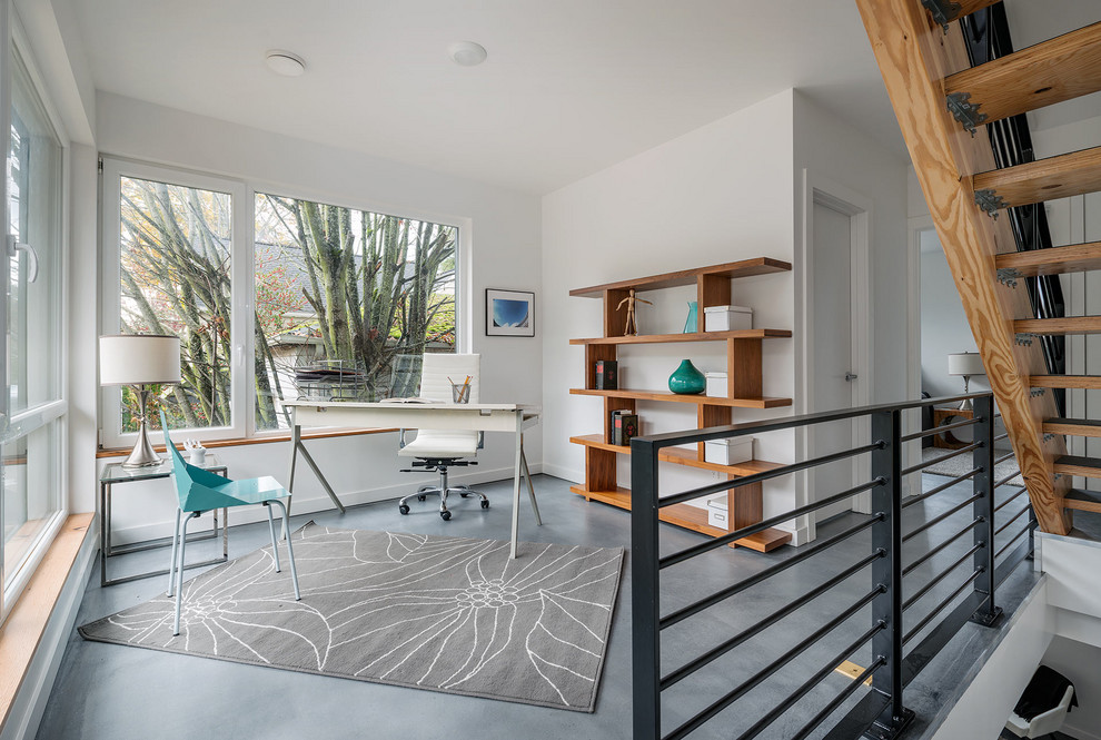 Home office - mid-sized modern freestanding desk concrete floor and gray floor home office idea in Seattle with white walls and no fireplace