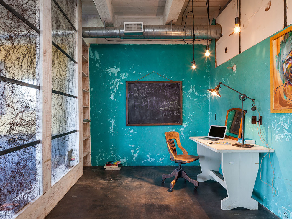 Mid-sized urban freestanding desk concrete floor and black floor study room photo in Portland with blue walls and no fireplace