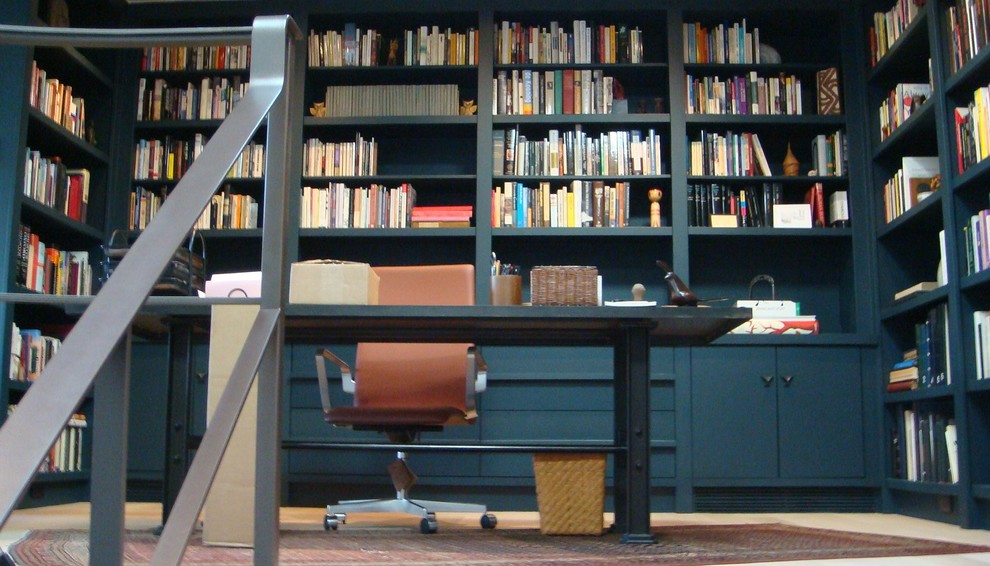 アトランタにある中くらいなコンテンポラリースタイルのおしゃれなホームオフィス・書斎 (ライブラリー、青い壁、暖炉なし、自立型机、ベージュの床) の写真