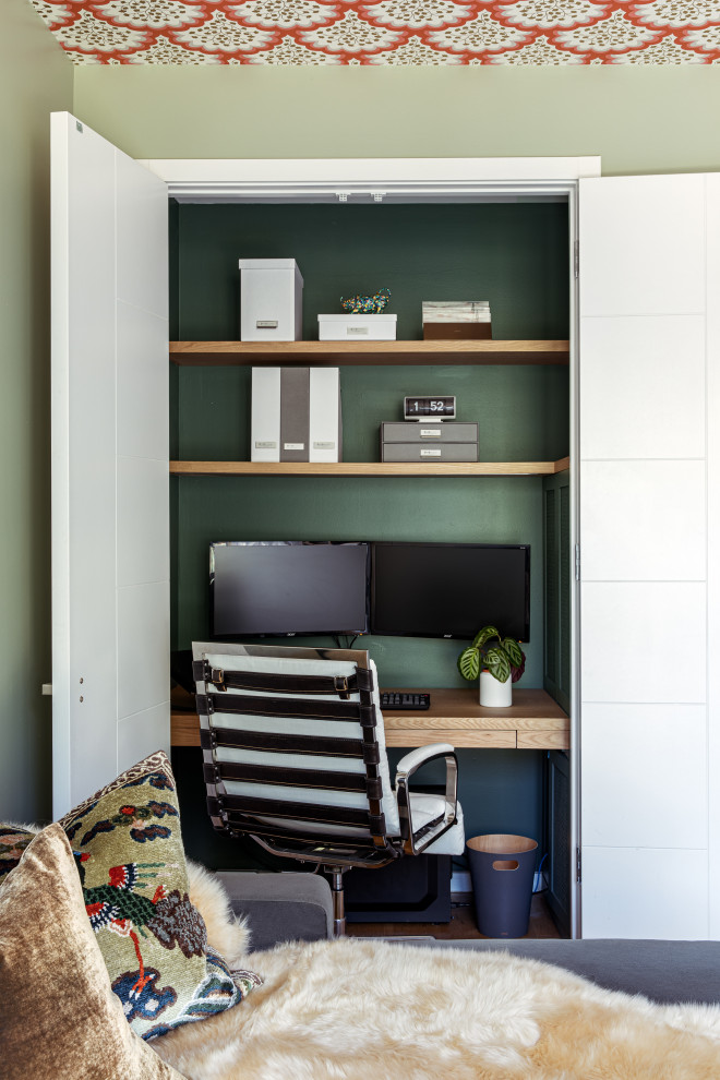 Home office - eclectic built-in desk home office idea in Austin with green walls