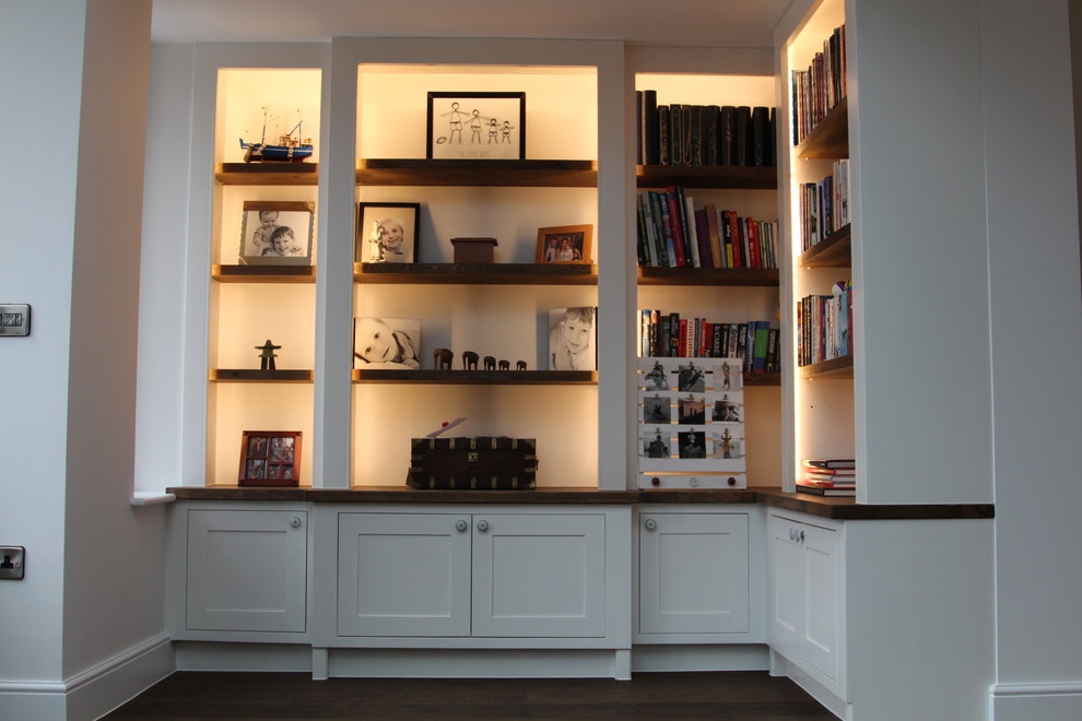 Inspiration for a medium sized traditional home office in London with white walls and dark hardwood flooring.
