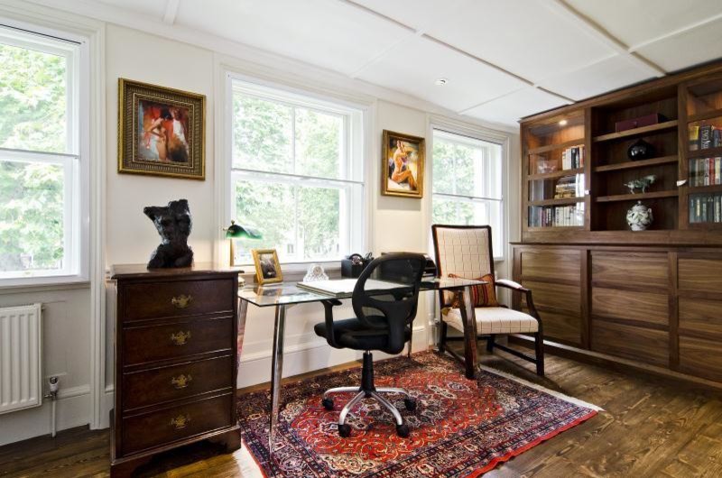 Medium sized contemporary study in San Francisco with beige walls, dark hardwood flooring and a freestanding desk.