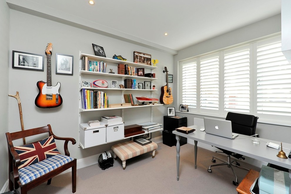 Classic home office in London with grey walls, carpet and a freestanding desk.