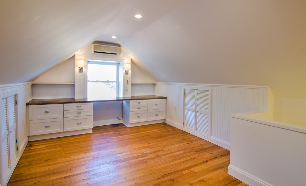 Photo of a classic study in DC Metro with white walls, light hardwood flooring, no fireplace and a built-in desk.