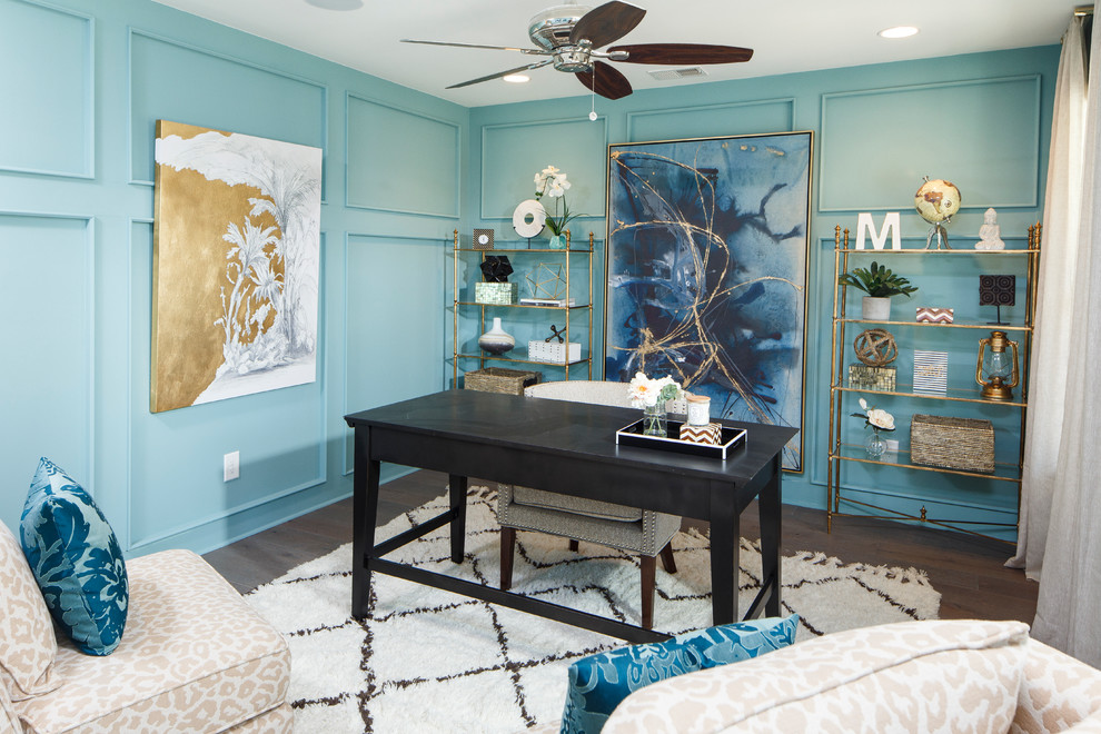 Example of a beach style freestanding desk medium tone wood floor study room design in Charleston with blue walls