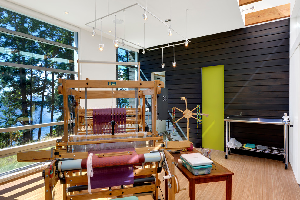 Exempel på ett modernt hemmastudio, med bambugolv, vita väggar och ett fristående skrivbord