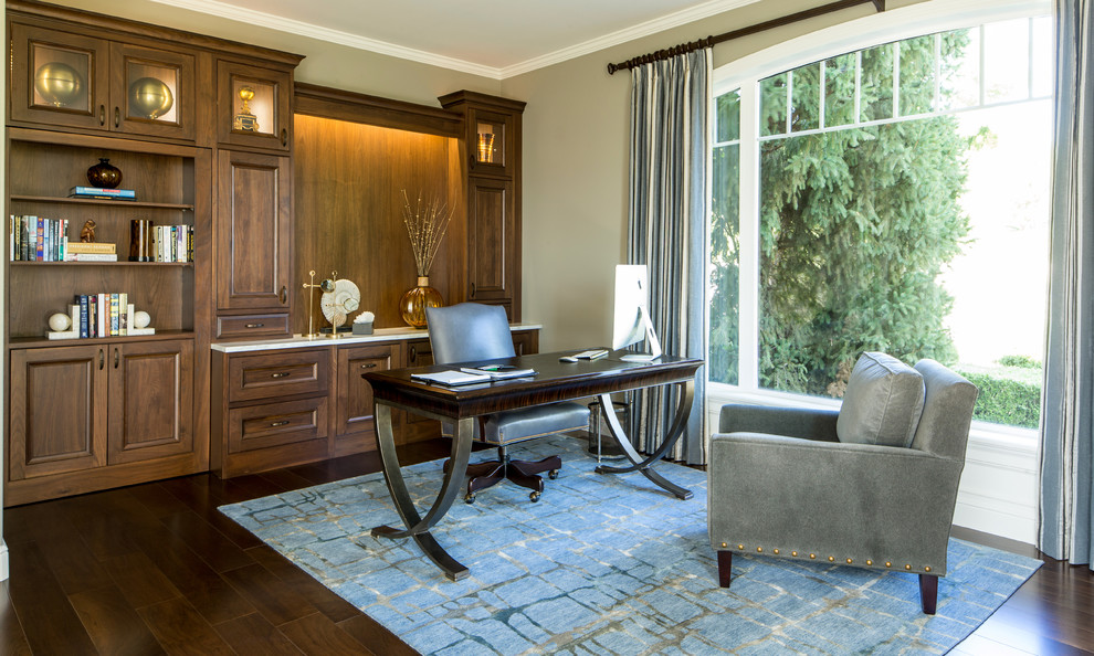 Large transitional freestanding desk dark wood floor study room photo in Seattle with beige walls and no fireplace