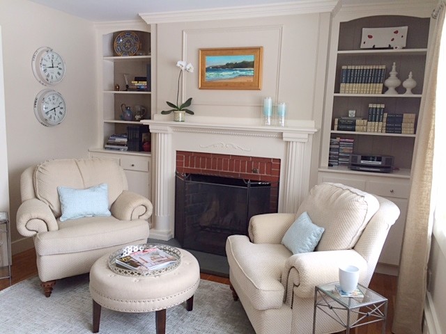 Inspiration for a medium sized traditional study in Boston with beige walls, medium hardwood flooring, a standard fireplace, a brick fireplace surround and a freestanding desk.