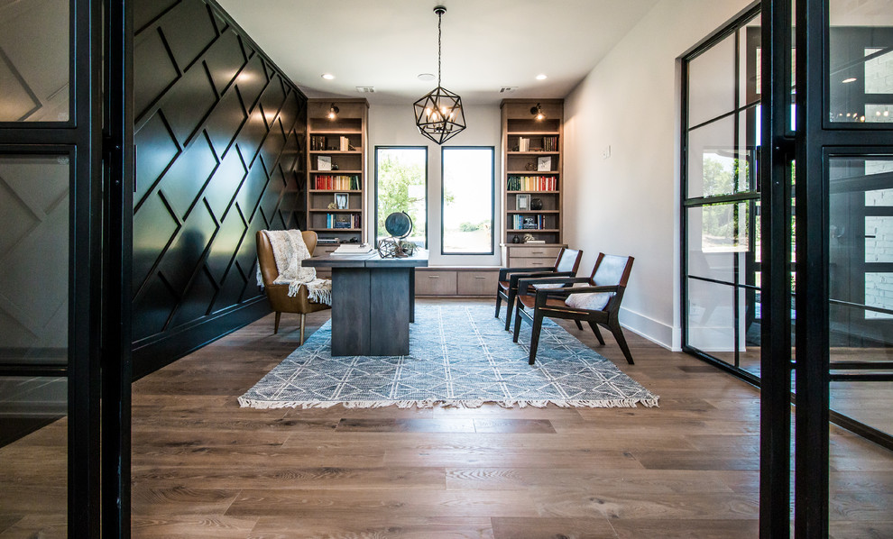 Photo of a large contemporary home office in Other with white walls, medium hardwood flooring, a freestanding desk, brown floors and no fireplace.