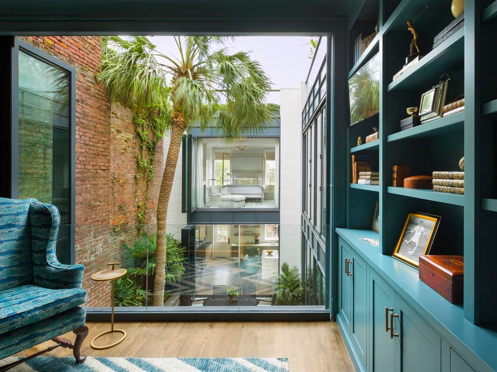 アトランタにあるトランジショナルスタイルのおしゃれなホームオフィス・書斎 (ライブラリー、青い壁、淡色無垢フローリング、暖炉なし、ベージュの床) の写真