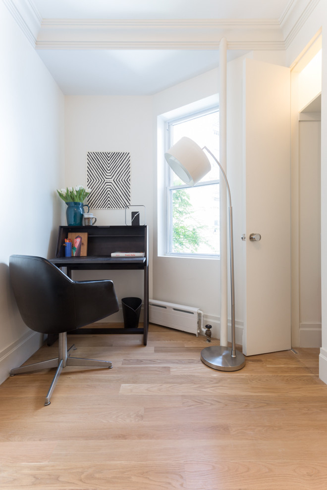 Small transitional freestanding desk light wood floor study room photo in New York with white walls and no fireplace
