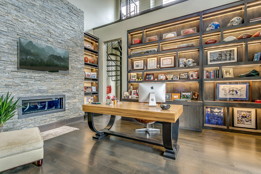 Transitional freestanding desk dark wood floor study room photo in Dallas with beige walls and a ribbon fireplace