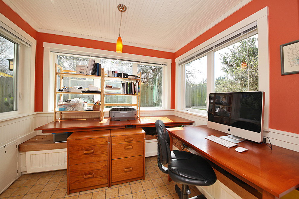 Diseño de despacho clásico de tamaño medio con escritorio independiente, parades naranjas y suelo de baldosas de cerámica