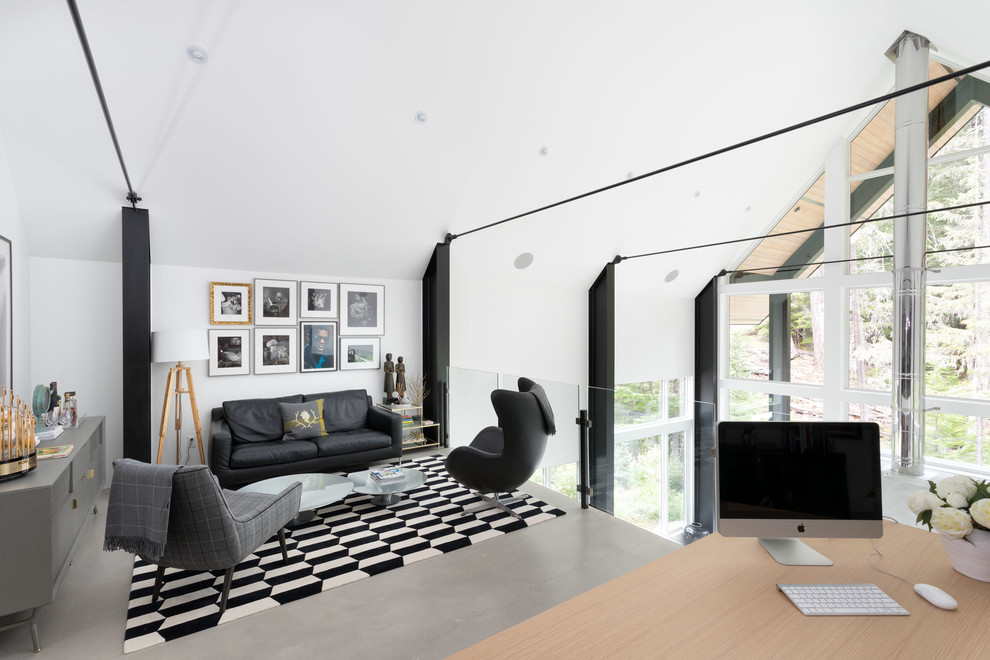 This is an example of a scandi study in Other with white walls, concrete flooring and grey floors.