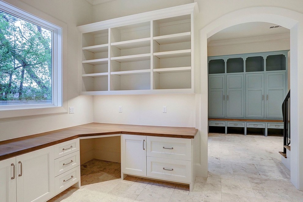 This is an example of a traditional craft room in Houston with white walls and a built-in desk.