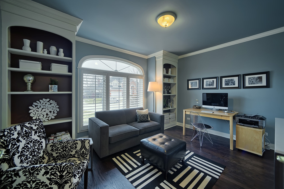 Diseño de despacho contemporáneo con paredes azules, suelo de madera oscura y escritorio independiente