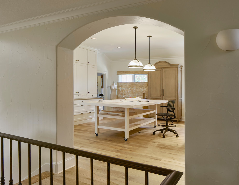 Cette image montre un grand bureau traditionnel de type studio avec un mur blanc, parquet clair, aucune cheminée, un bureau indépendant et un sol beige.