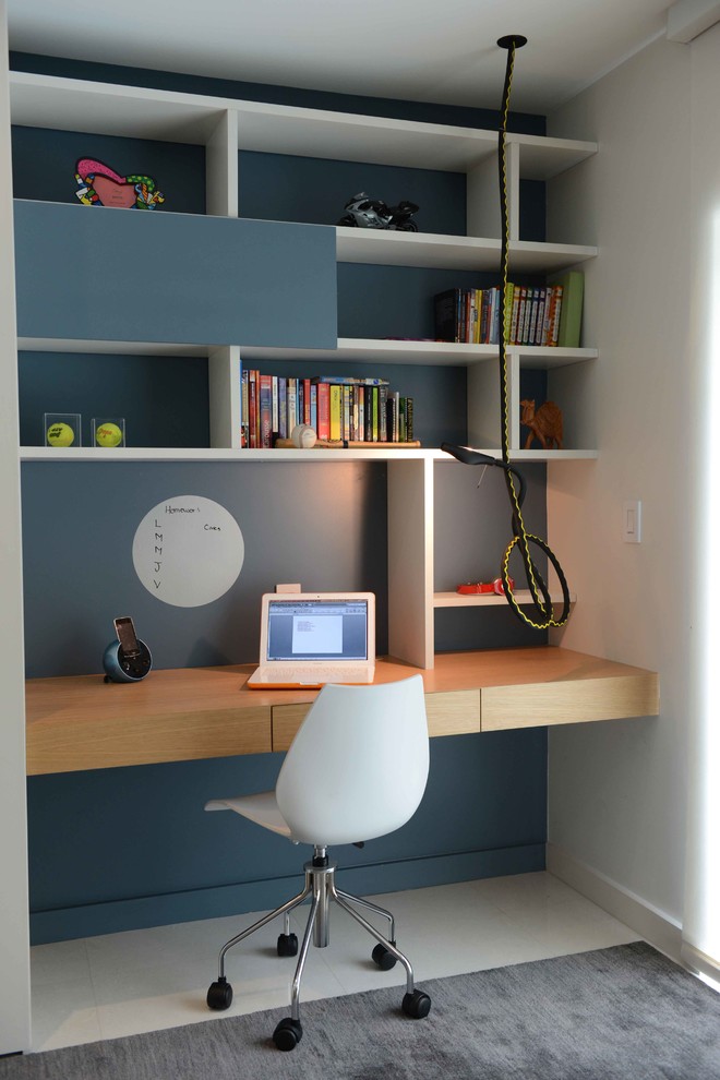 Contemporary home office in Miami with a built-in desk.