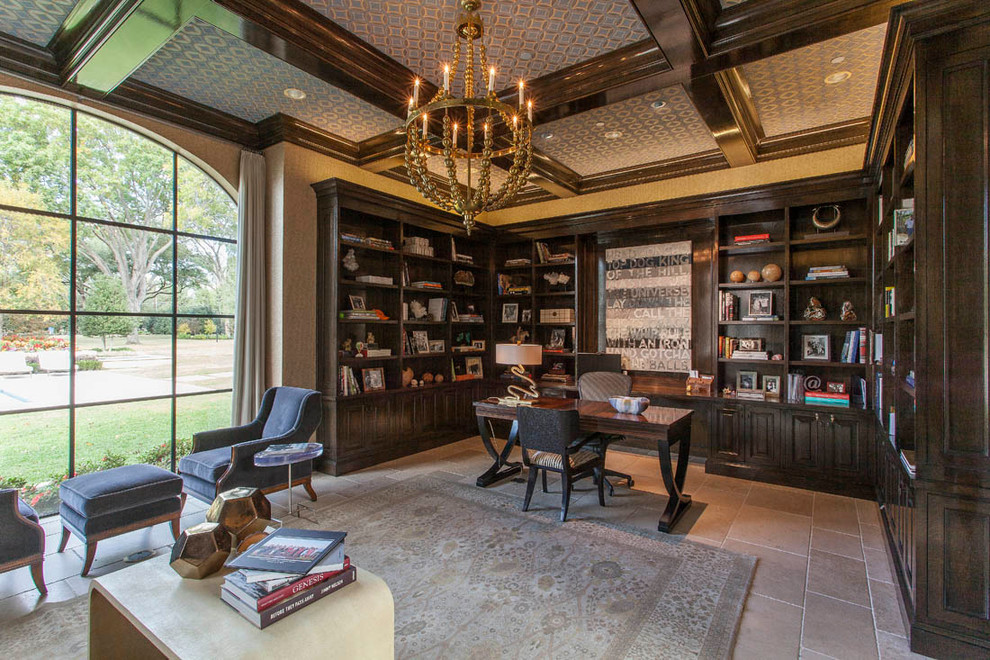 This is an example of a mediterranean study in Dallas with beige walls, limestone flooring and a freestanding desk.