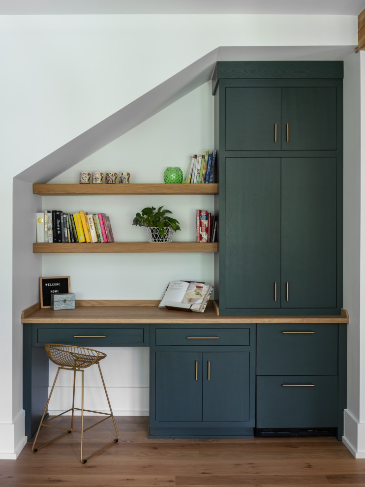 Home office - large cottage medium tone wood floor and brown floor home office idea in New Orleans