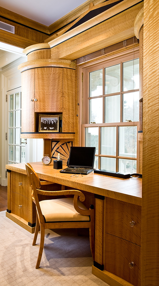 Small classic home office in Boston with light hardwood flooring and a built-in desk.