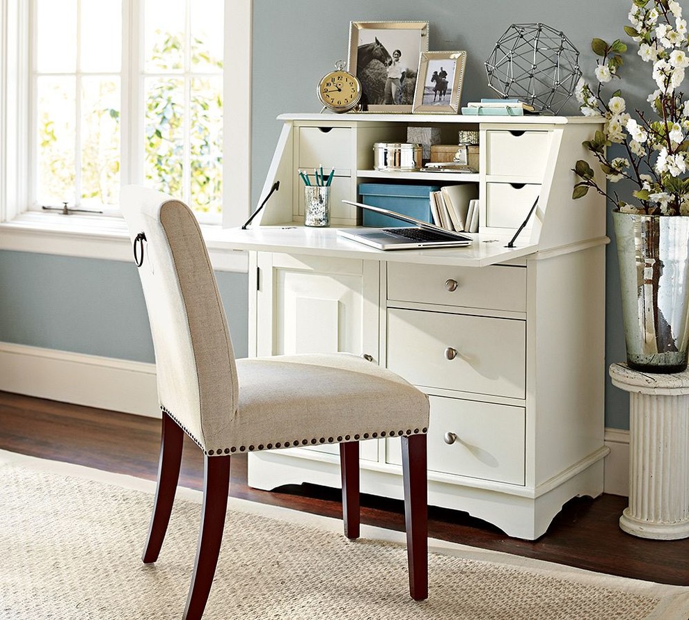 Small elegant freestanding desk dark wood floor home office photo in Sacramento with blue walls